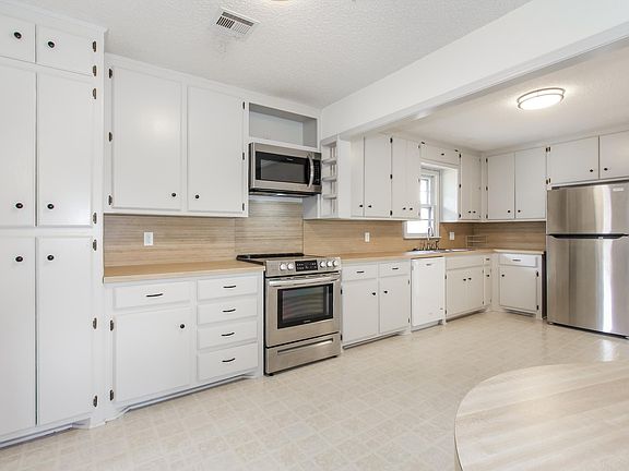 Updated oversized kitchen with new appliances, paint and hardware. Lots of storage.