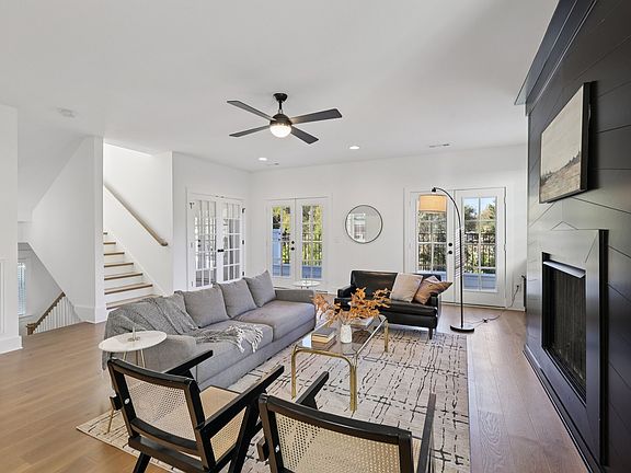 Living room featuring fireplace detail, recessed lighting, and oversized windows.