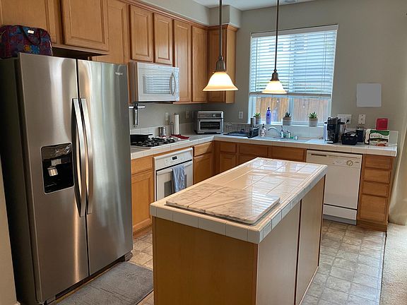 Kitchen: The microwave and refrigerator are new. To the left of the refrigerator is a large pantry.