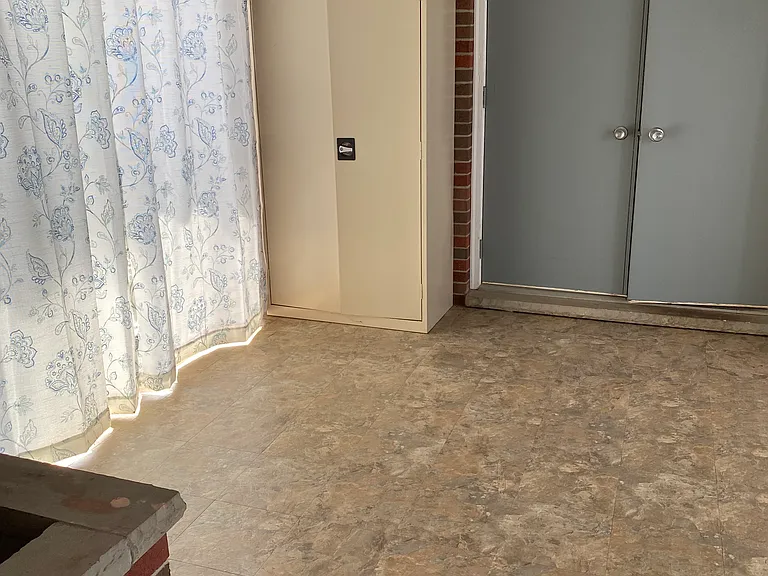 Breezeway room wit three metal storage cabinets
