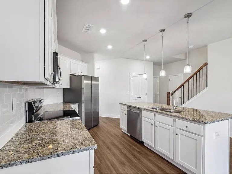 A view of the spacious kitchen and stainless steel appliances
