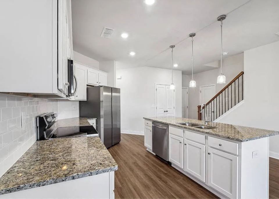 A view of the spacious kitchen and stainless steel appliances