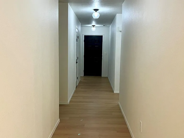 Corridor to front door from living area