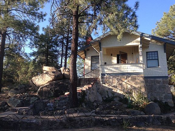 House, boulders and pines