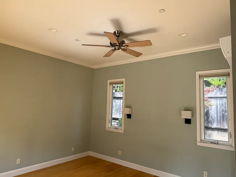 Primary bedroom with 10ft ceilings, ensuite bathroom and AC.