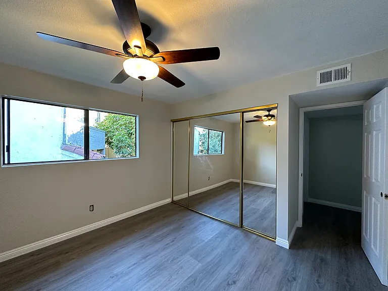 Bedroom 2 with mrrored doors over 8 ft closet