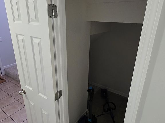 Hidden storage area under the staircase.