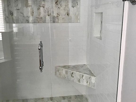 Beautiful large marble shower with frameless glass doors