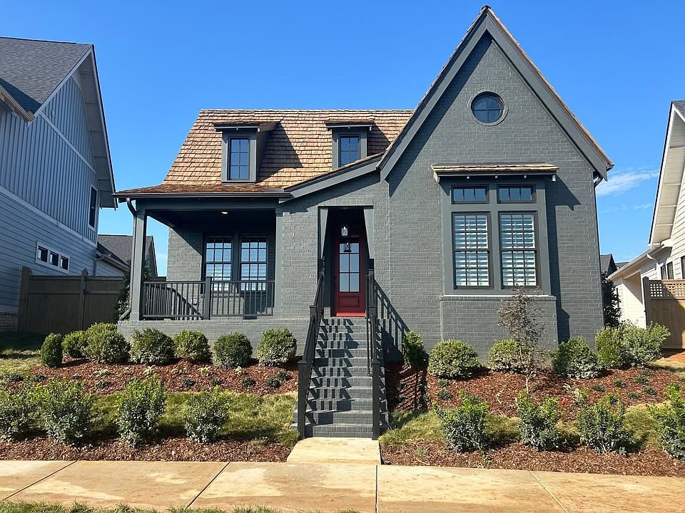 Charming cottage appeal with cedar shake roof in prime location with lake view.