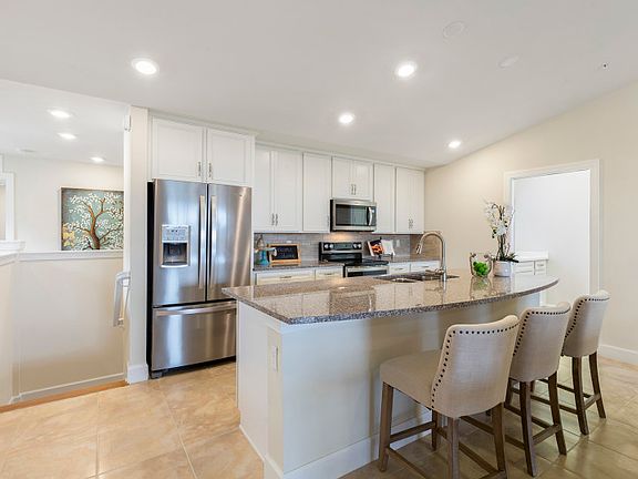 Model Representation Well appointed kitchen with stainless appliances and granite countertops