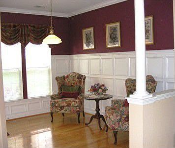 Sunroom with artisan crafted picture framing adorn the walls