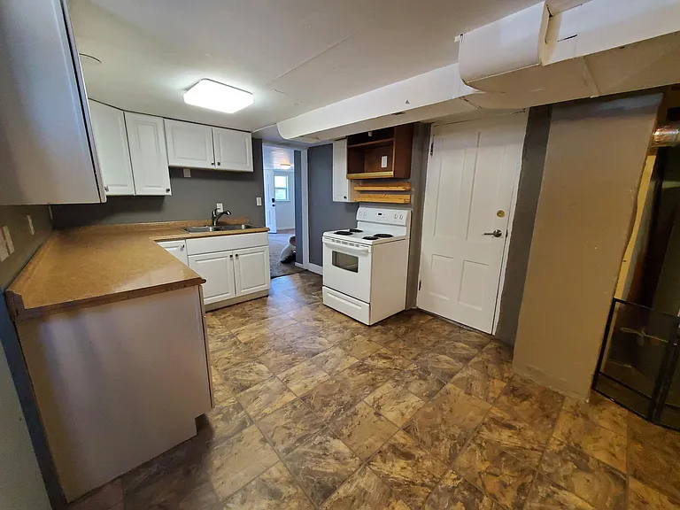 Kitchen with stainless steal, fridge, stove/oven, microwave, stainless steal double sink, sprayer, and garbage disposal.
