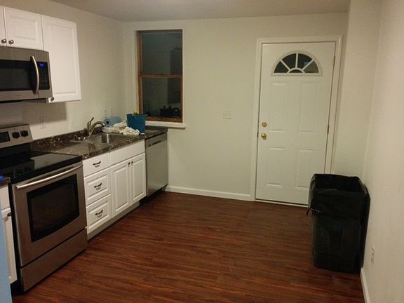 Backdoor leading out to shared gated patio w/ keyed access t