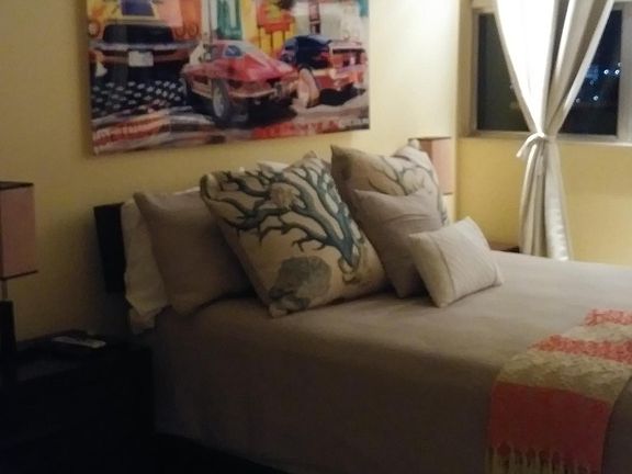 bedroom with balcony facing water 