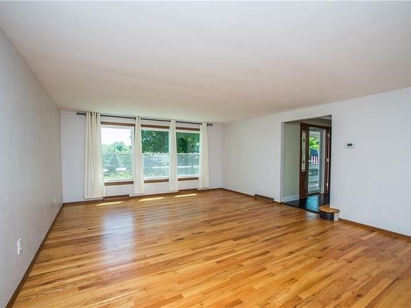 With neutral dcor, this room has tons of space for both a sitting area and an office/play area.