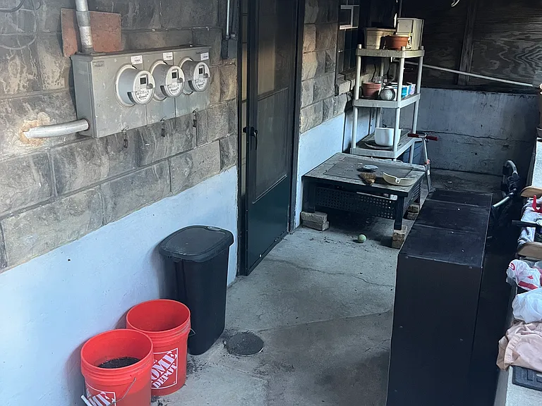 Entrance to the basement to access the laundry. Storage for tenant may be available in this area outside of the basement; tenant may discuss options with landlord and may set up a weather-proof storage shed or box for themselves here, if desired.