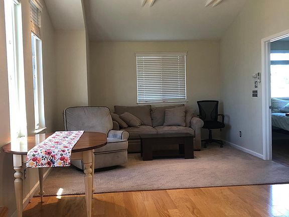 Living area with fold out couch, chairs, and table.