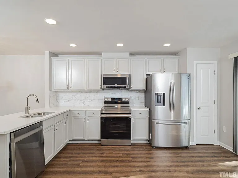 With plenty of cabinet space, there's no need to run out of storage space. There's a secondary closet located where the photographer is standing too!