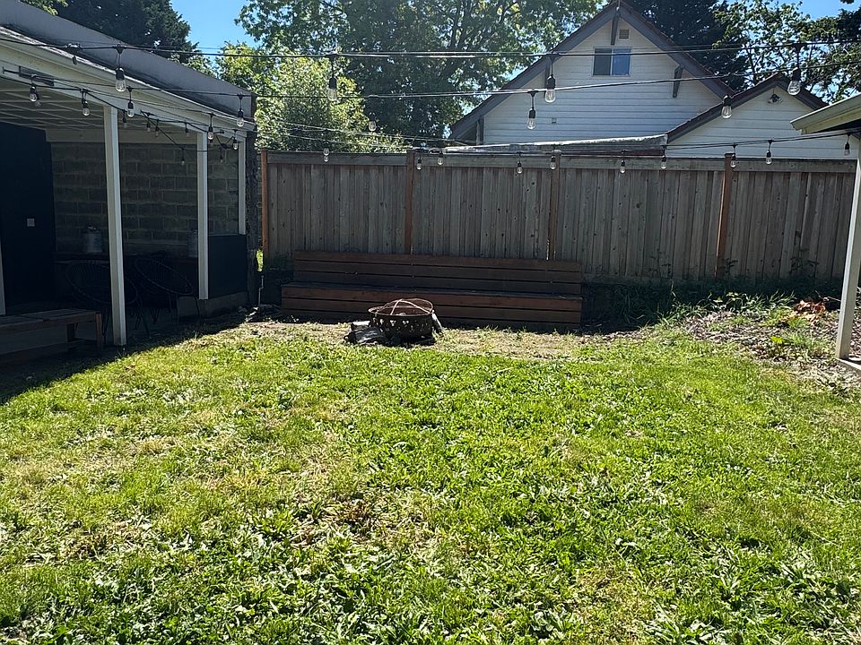 Yard with fire pit and seating area.