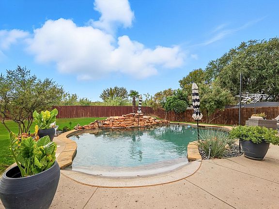 View of swimming pool with a fenced backyard and a patio area