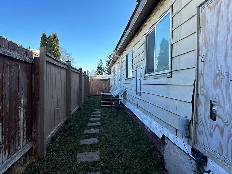 Sideyard with door outside laundry room.