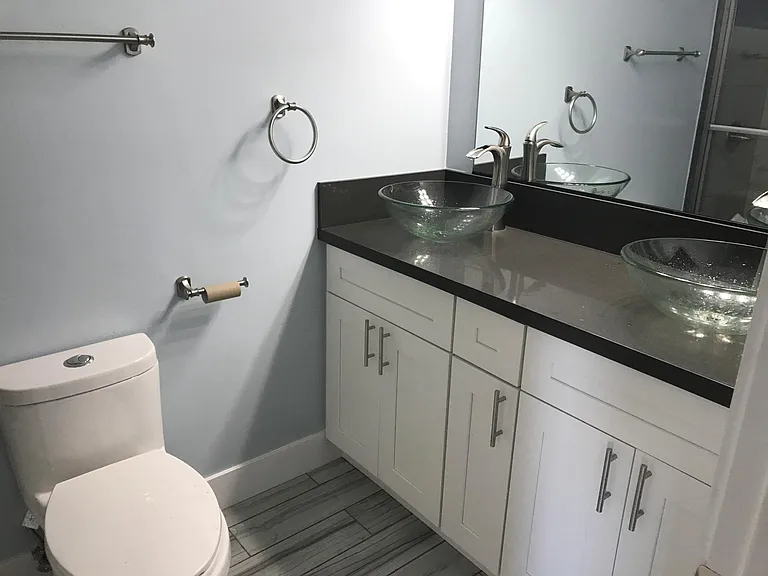 Shared bathroom with dual sinks