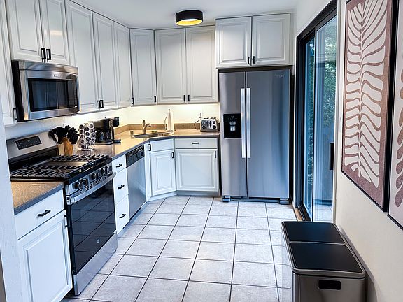 A true highlight _ bright, spacious, and fully equipped. Stainless steel appliances. Gas range, microwave, dishwasher. Coffee maker + Keurig. Toaster, full knife block, cookware, spices, and essentials Sliding door with direct access to deck.