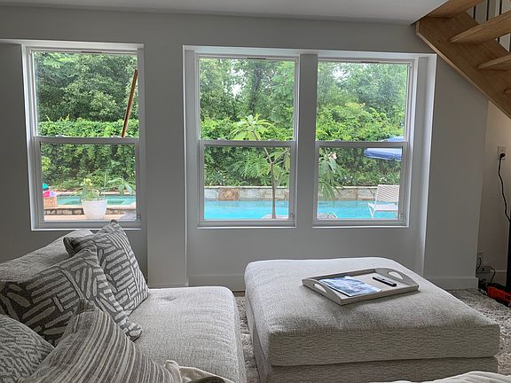 downstairs living area looks out to pool , french doors lead out
