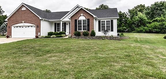Manicured lawns and landscaping surround the home on the .75 acre level lot