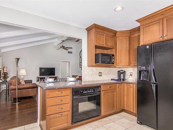 Kitchen has 2 Full sized 30 inch ovens which face each other and granite counters.