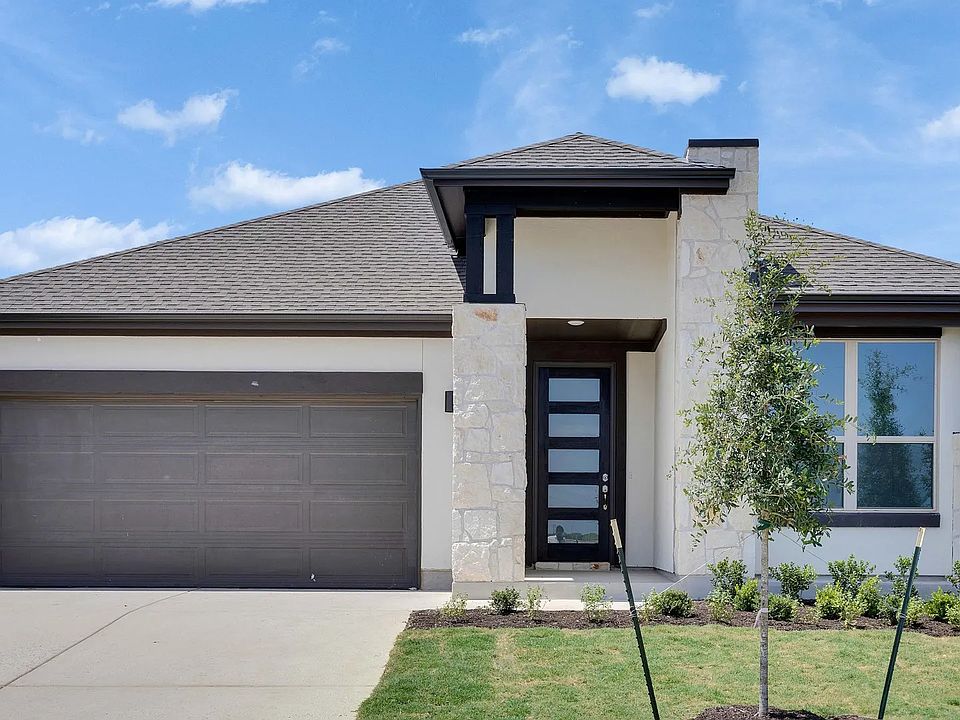 This exquisite stone facade and modern design define luxury in the serene Lakeside Meadows estate.