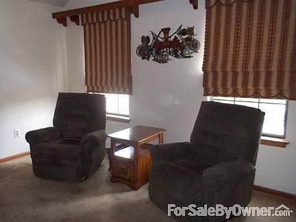 DEN
						:
						Cozy Den with Cathedral Ceiling, Built-In Bookcase and Custom Window Treatments