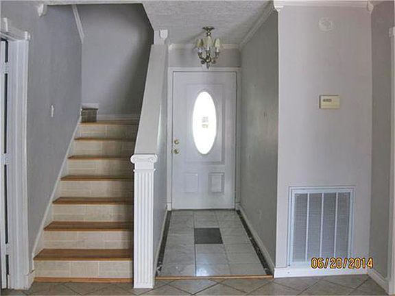 Enter through the front door and note the tile and laminate floors throughout.