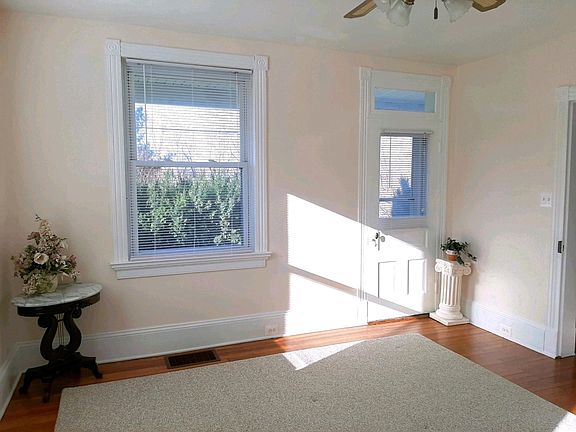 Master bedroom. With high ceilings and many large energy efficient Thermopane windows, the apartment is very bright and open. Notice the lovely architectural details with transom windows, fancy trim and ceiling fans.