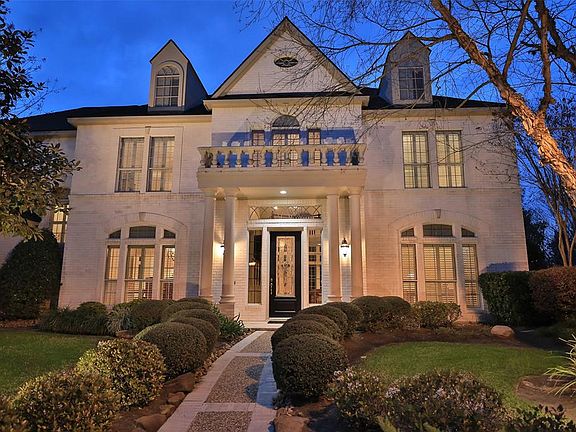 STUNNING ARCHITECTURE WITH ATTENTION TO DETAIL - This fabulous entrance features a decorative stone walk way leading to a custom front door with leaded glass inserts, side panels and a transom window. Every detail of this home has been thoughtfully l