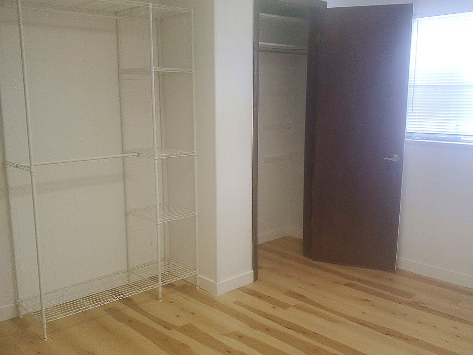 12 x 13' Bedroom with closet and extra clothing storage rack.