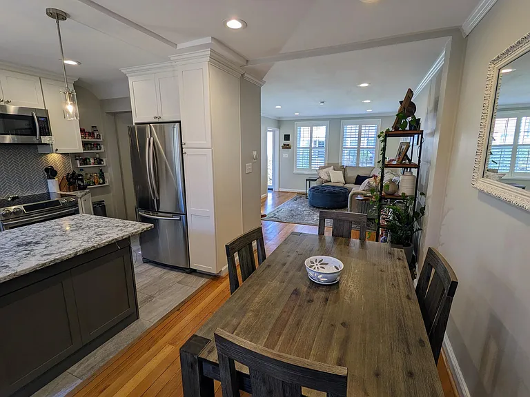 Open floor plan with gleaming original hard wood floors and new tile.