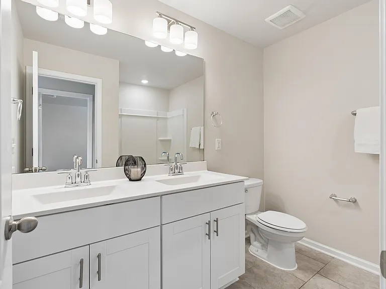 Full bathroom with a double vanity with upgraded lighting !