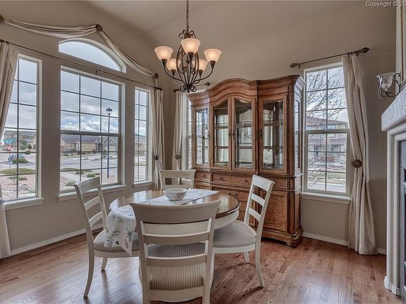 The formal dining room has two walls of windows to allow in plenty of natural li