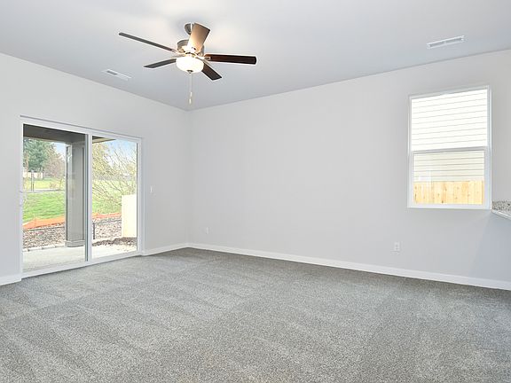 The family room is spacious with a ceiling fan.
