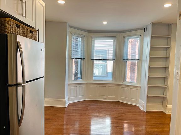 Front room with bay window and book shelf