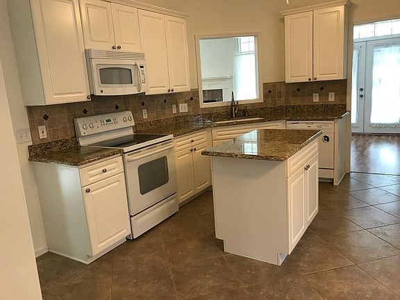 Upgraded kitchen with granite countertops and plenty of stor