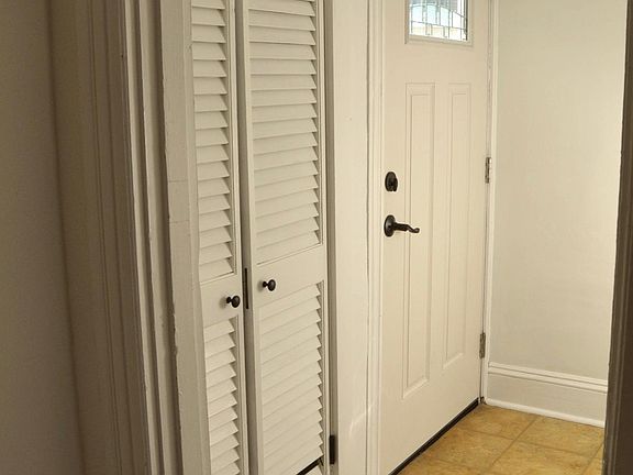 Front entryway with coat closet and tile floor. Freshly pained.