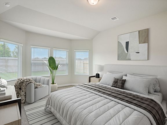 The primary bedroom of a home in Wall Street Village of Richmond, TX.