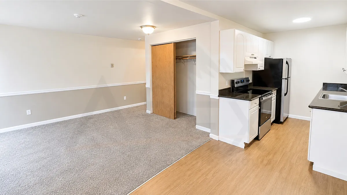 Functional open-concept studio with a convenient kitchen layout, ample cabinet storage, and easy flow into the living area. - 1146 N 91st St #103