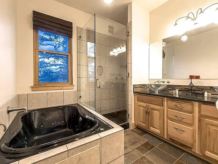 Jetted tub in the primary bathroom - great for a soak while you watch the snow fall on the mature spruce trees out the window