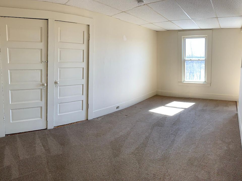Living room showing 1 walk in closet and 1 linen closet