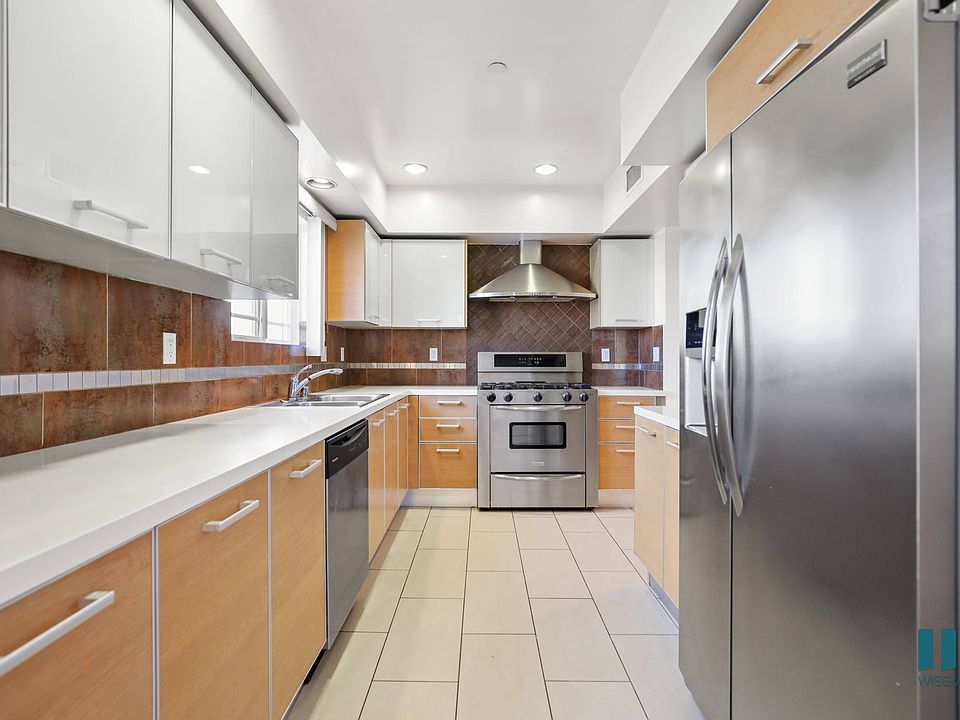 Large-Size Kitchen with Stainless-Steel Refrigerator, Stove, Microwave Oven, and Dishwasher
