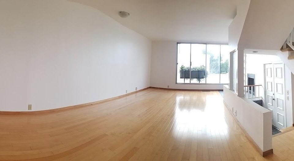 wide angle view of living room and entry way