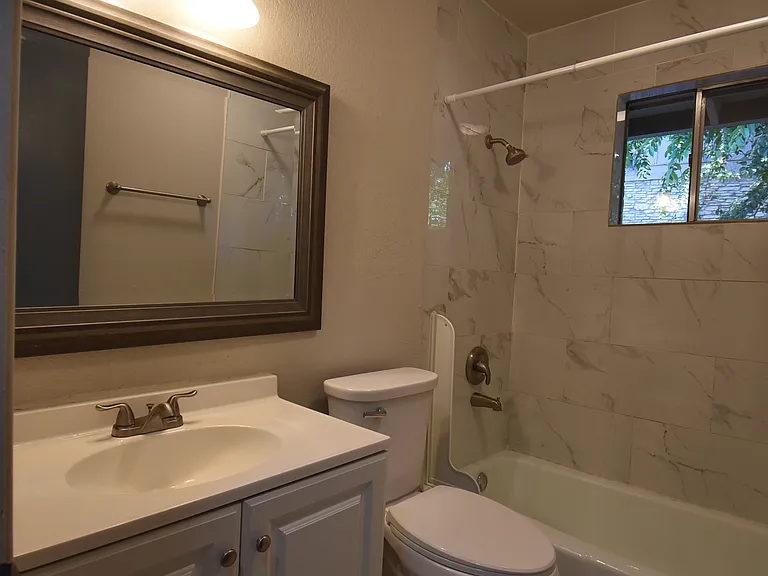 Full bathroom with a vanity and bathtub